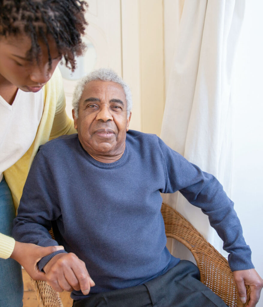 man in blue shirt being assisted in chair