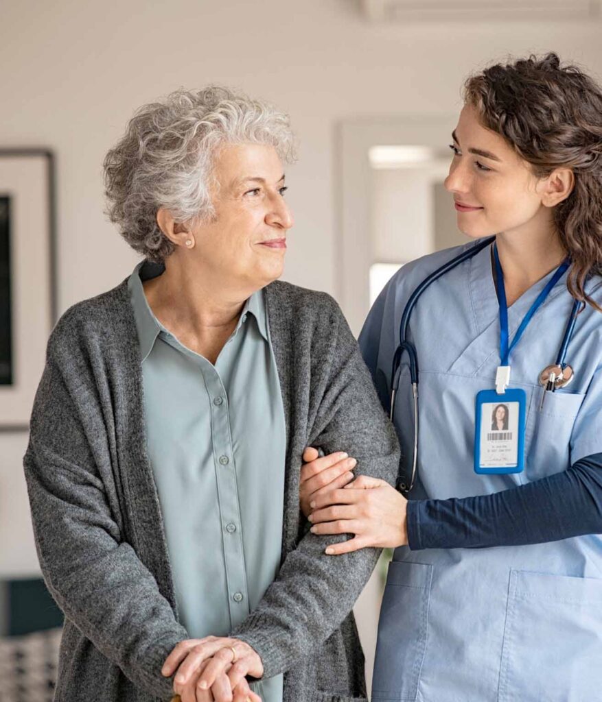 Img of nurse holding elderly woman by arm