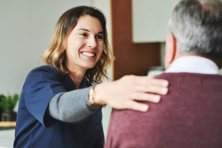 Lifted Hospice nurse in scrubs helping elderly